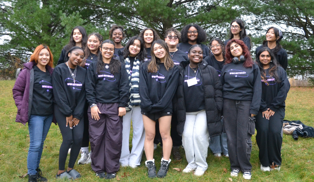 Group of LUCES community members posing for a photo in front of trees at LUREC.